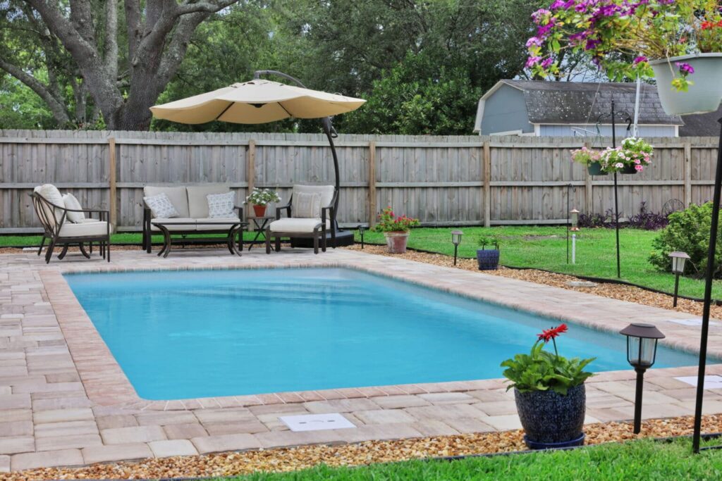 Backyard pool with seating area.