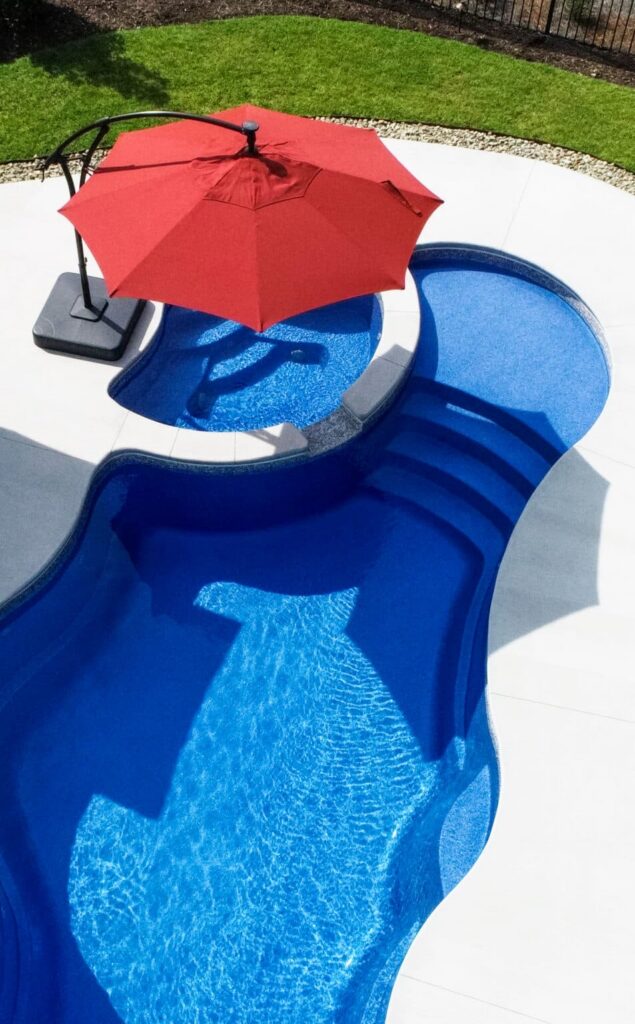 Blue pool with red umbrella shade