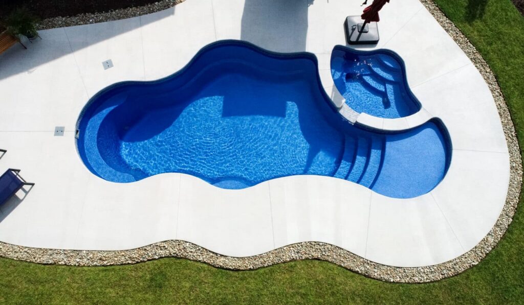 Curved swimming pool with spa area