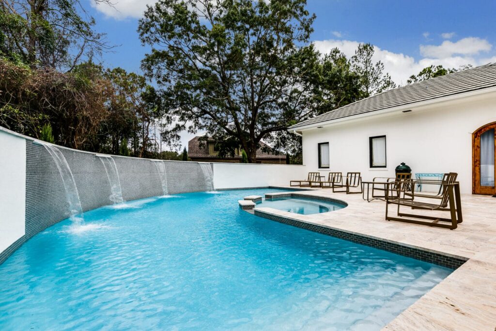 Modern pool with waterfall features.