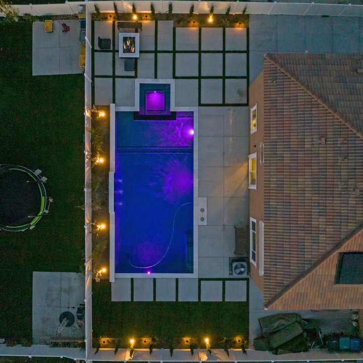 Aerial view of illuminated backyard pool