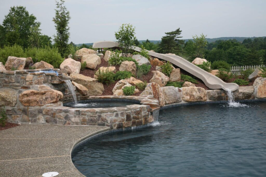 Pool with slide and natural landscaping