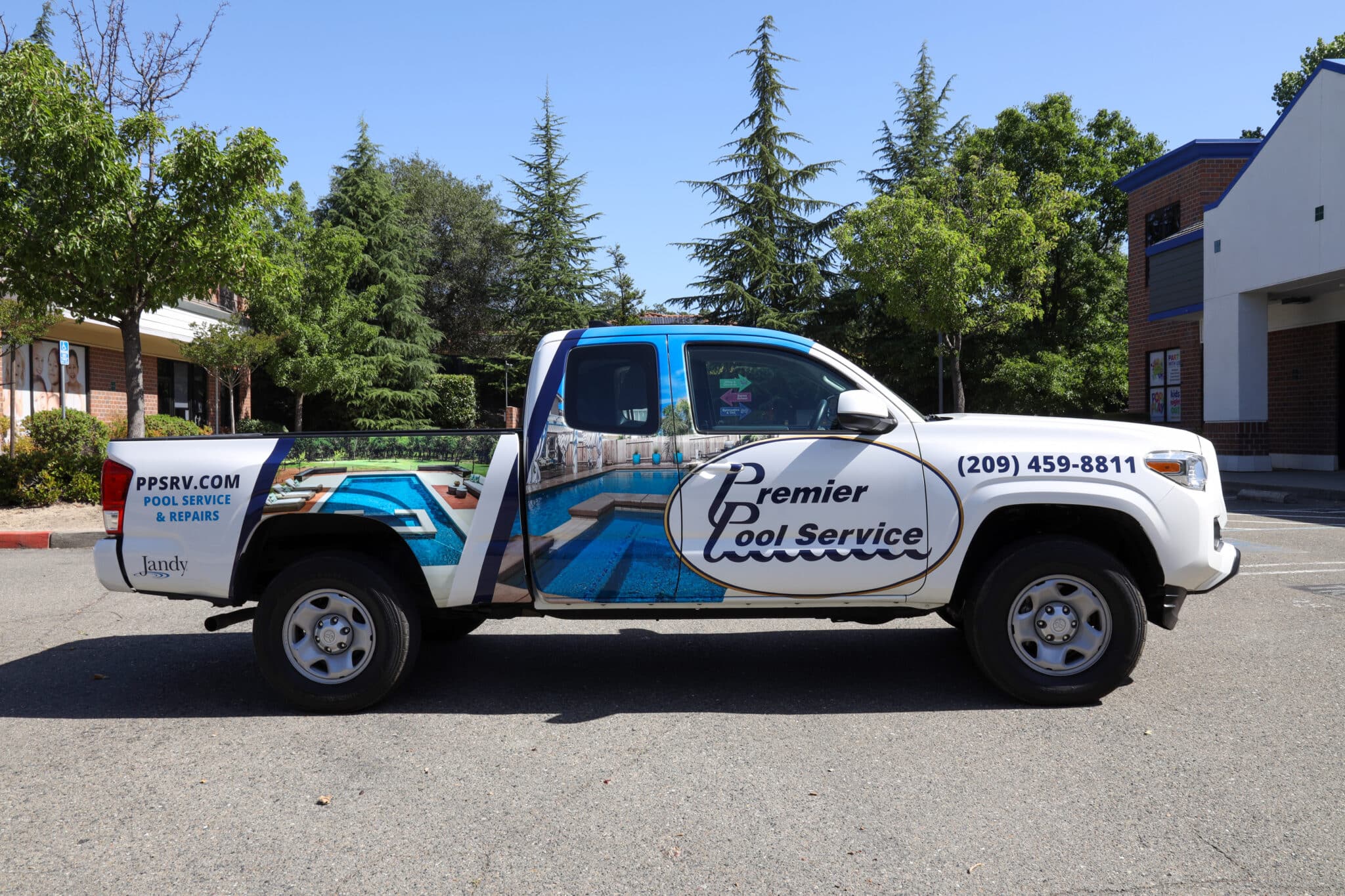 White truck with premier pool service branding